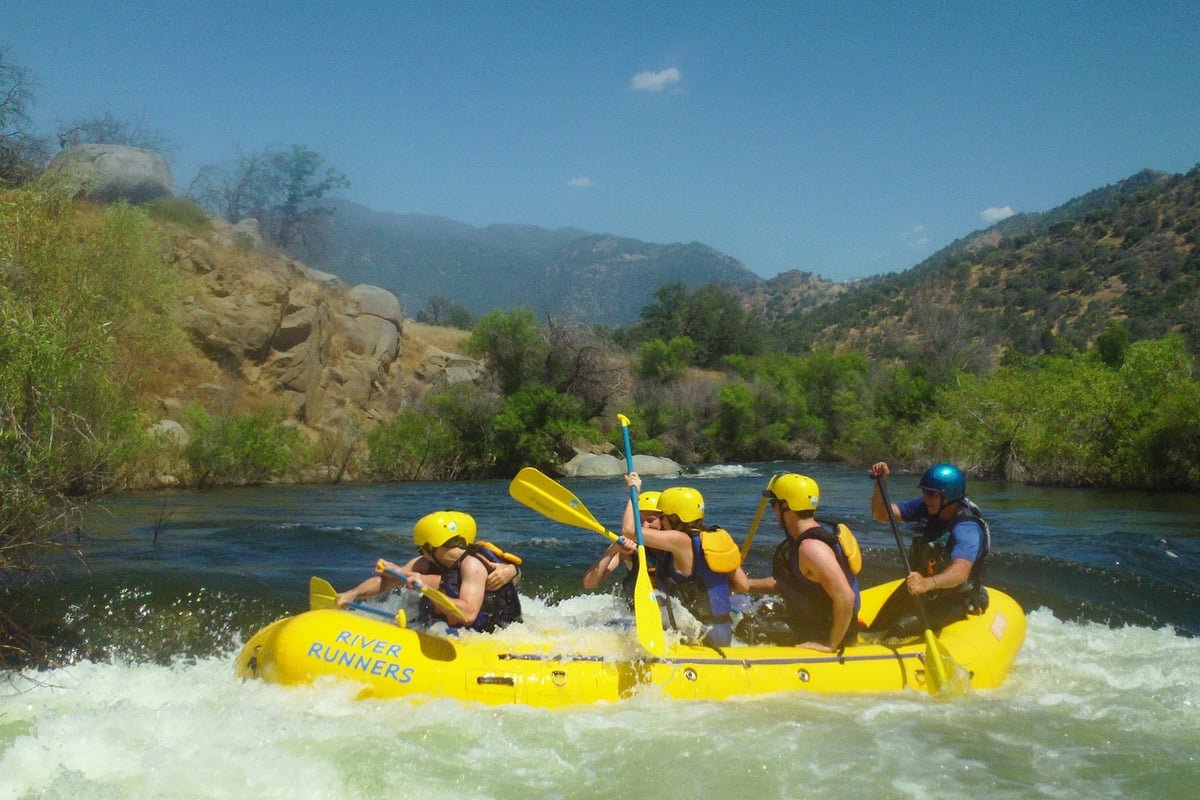 Exciting white-water river rafting navigating through rapids on the mountain river