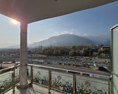 Balcony with decorative etched glass railings under warm Himalayan sunshine